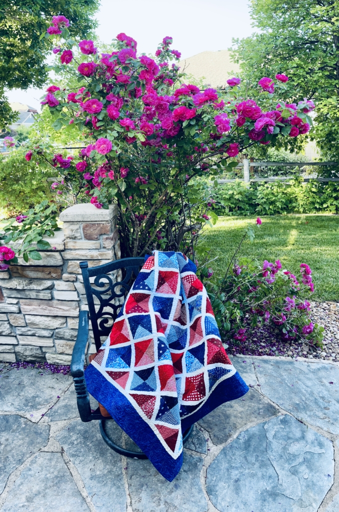 Patriotic scrap quilt in rose garden